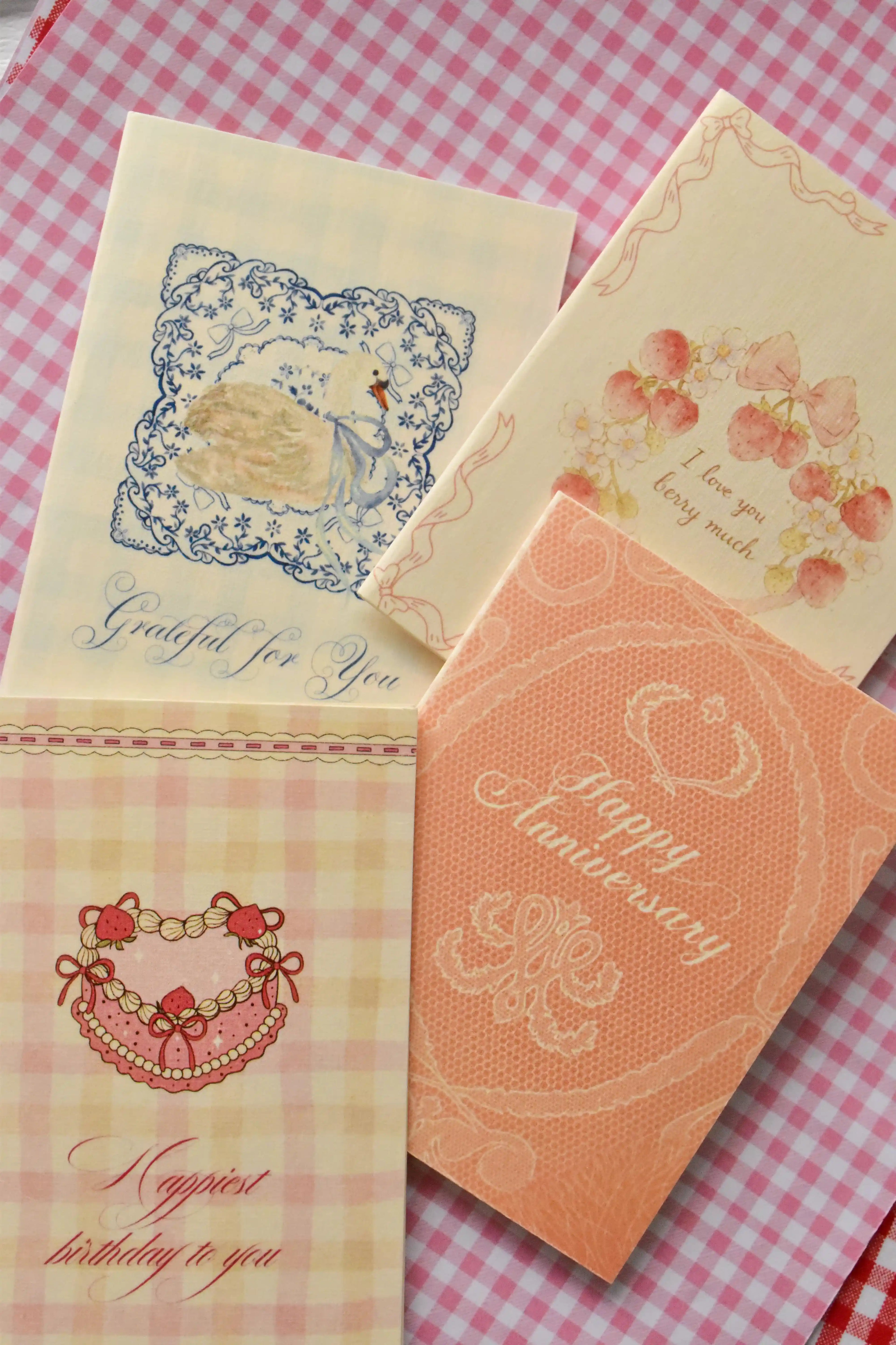 A different angle showing the charming variety of designs in the set, including the Grateful For You, Happy Anniversary, Love You Berry Much, and Happiest Birthday cards.