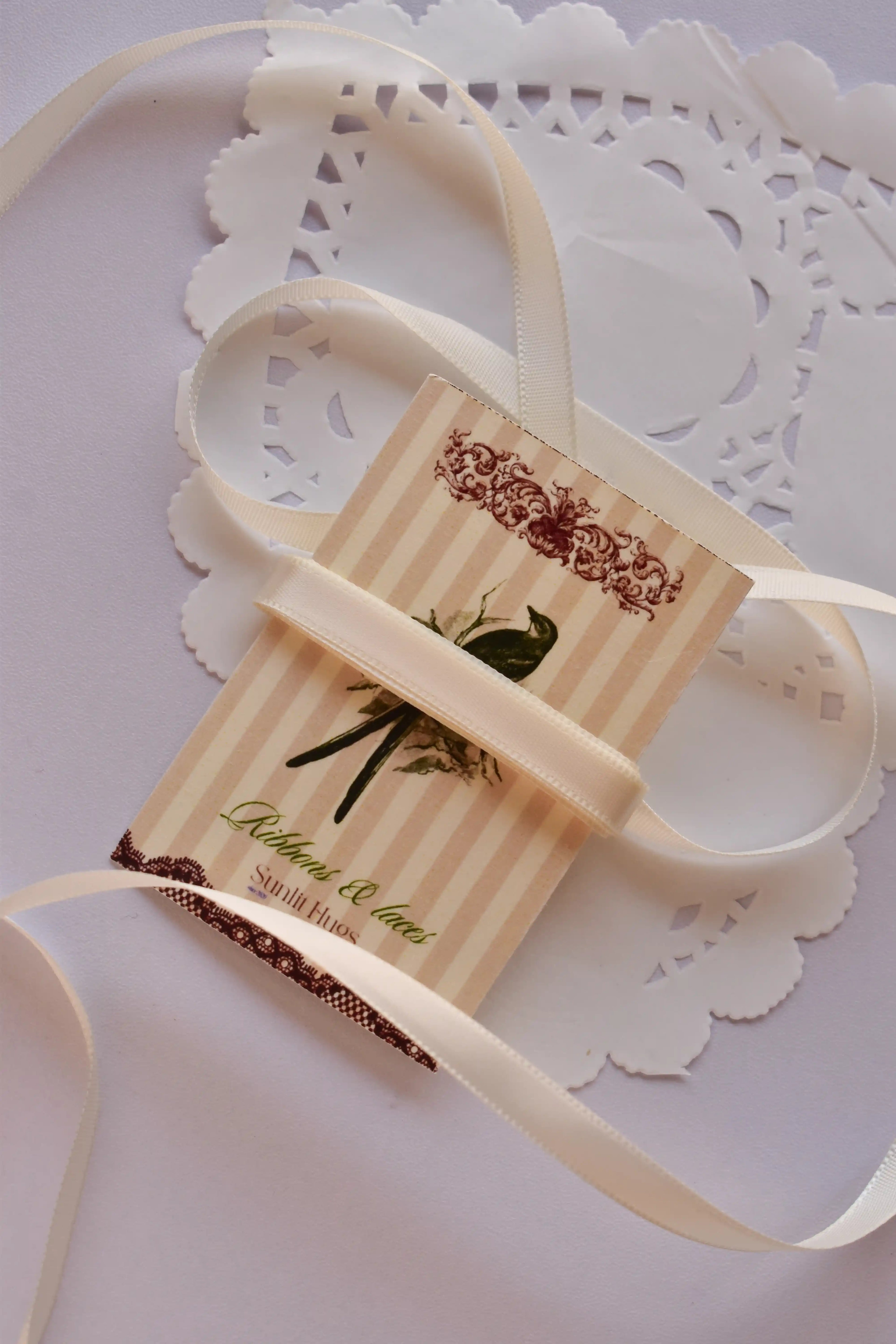 Narrow beige satin ribbon (6mm, 2 Metres) draped elegantly around a "Sunlit Hugs" card with a long, loose strand flowing down.