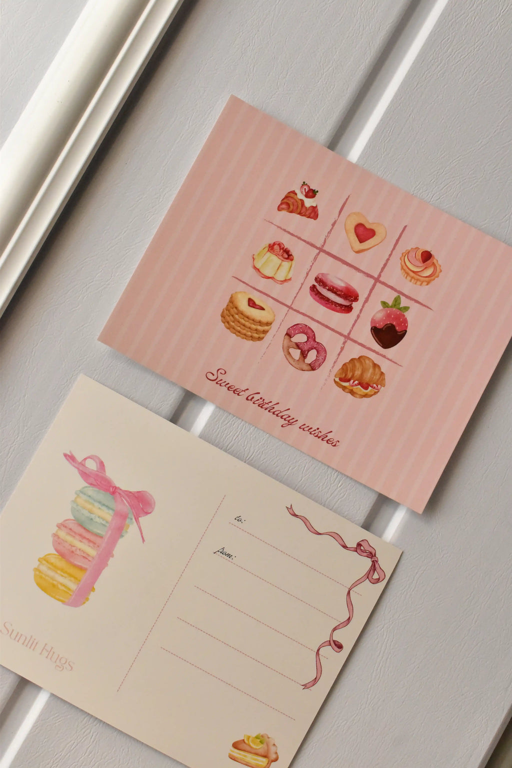 This side-by-side view displays the complete Birthday Bakes Postcard design, showing the dessert grid next to the elegant macaron tower on the address side.