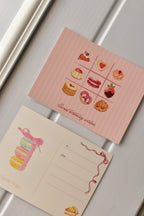 This side-by-side view displays the complete Birthday Bakes Postcard design, showing the dessert grid next to the elegant macaron tower on the address side.