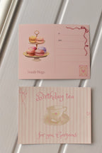 This image displays the full elegance of the Birthday Tea Postcard, highlighting the pink striped teacup design next to the beautiful macaron tier address panel.