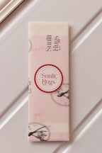 This image assures customers of the premium presentation, showing the Cake Bookmark carefully wrapped in Sunlit Hugs vellum paper, ready to be sent as a thoughtful gift.