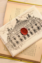 This angled shot clearly shows the rich Cherry Wine seal applied directly over the architectural vellum, demonstrating the beautiful layering and artistry of the handmade letter.

