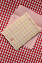 This image displays the back of the Happiest Birthday to You card. The continuous pink and cream gingham design and the Sunlit Hugs logo are visible, reinforcing the charming, cohesive look.