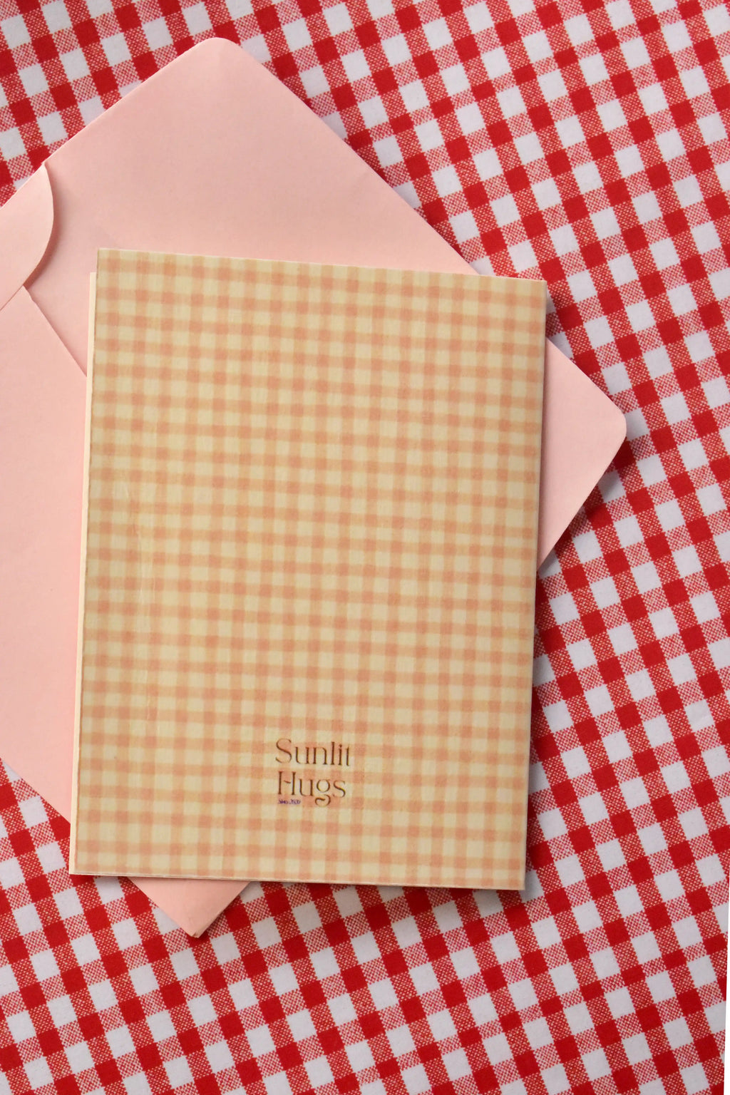 A view of the back of the Happy Anniversary card, featuring the subtle light peach and cream gingham design.