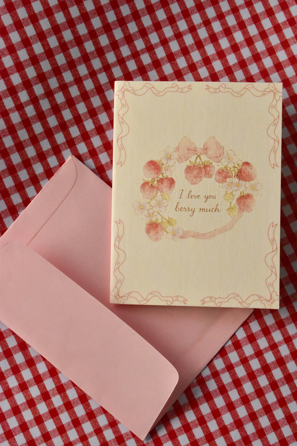 A close-up of the Love You Berry Much card, highlighting the sweet strawberry wreath and bow design—the perfect way to send a cheerful note of affection to a loved one.