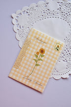 Front of the Mini Birthday Sunshine Card featuring a vibrant sunflower illustration on a yellow and cream gingham background.