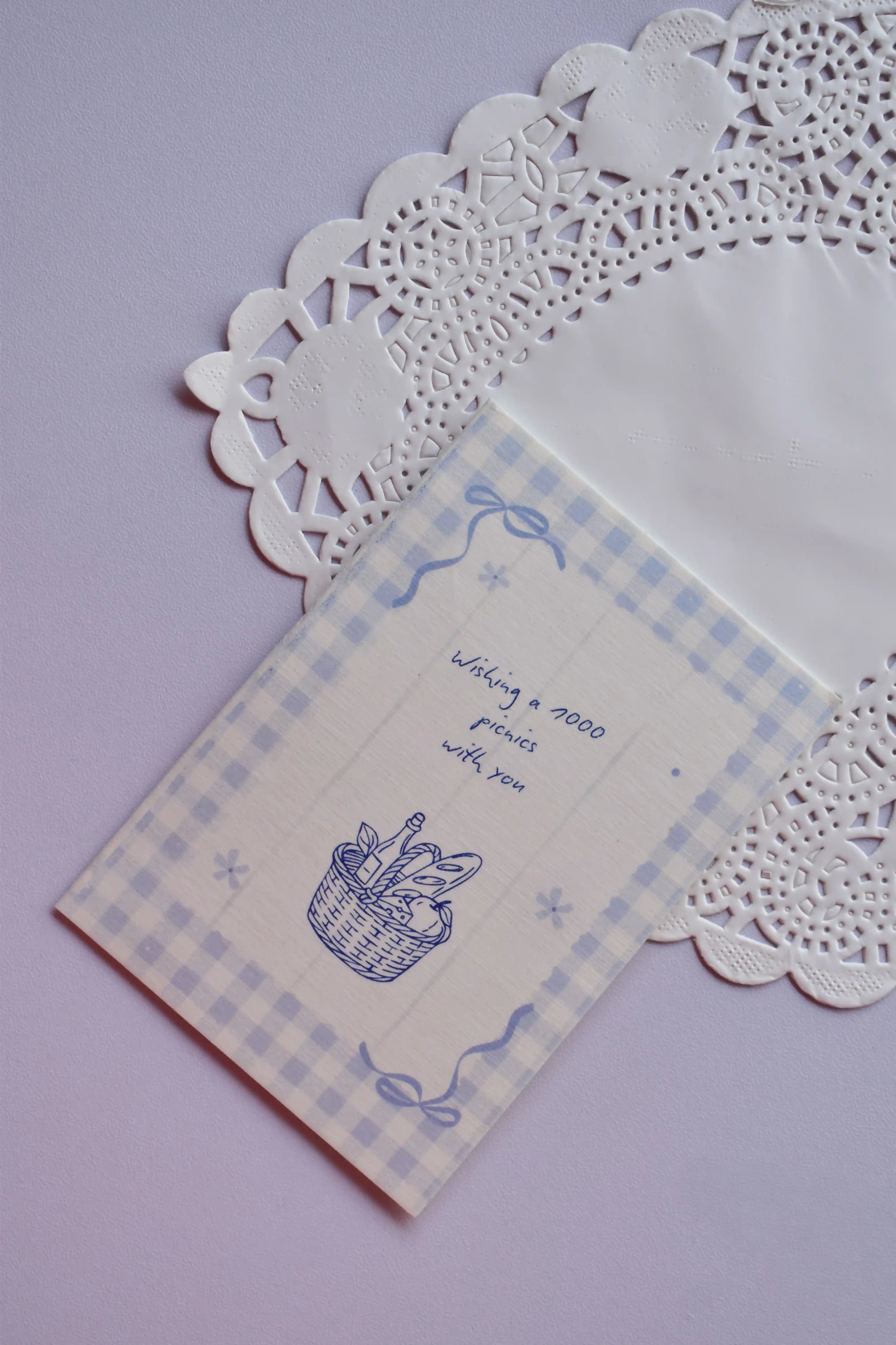 Front of the Mini Wishing Picnics Card featuring a blue gingham background and a picnic basket illustration.