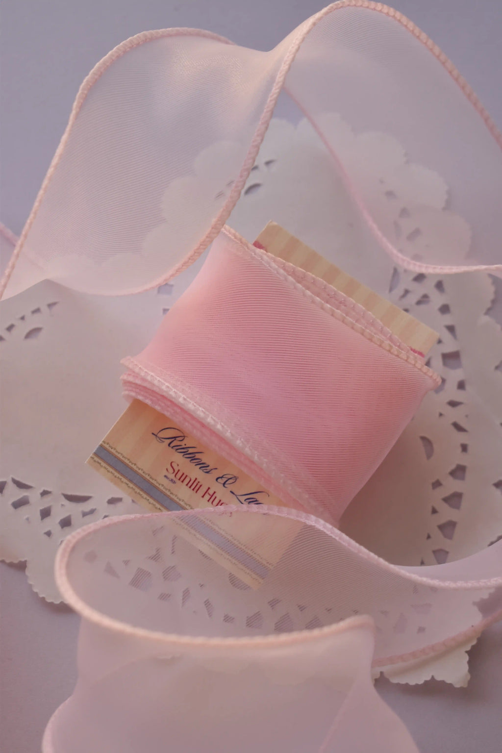 Wide pink sheer organza ribbon (40mm, 2 Metres) tightly wrapped around a "Sunlit Hugs" card, highlighting the sheer material and finished edge.