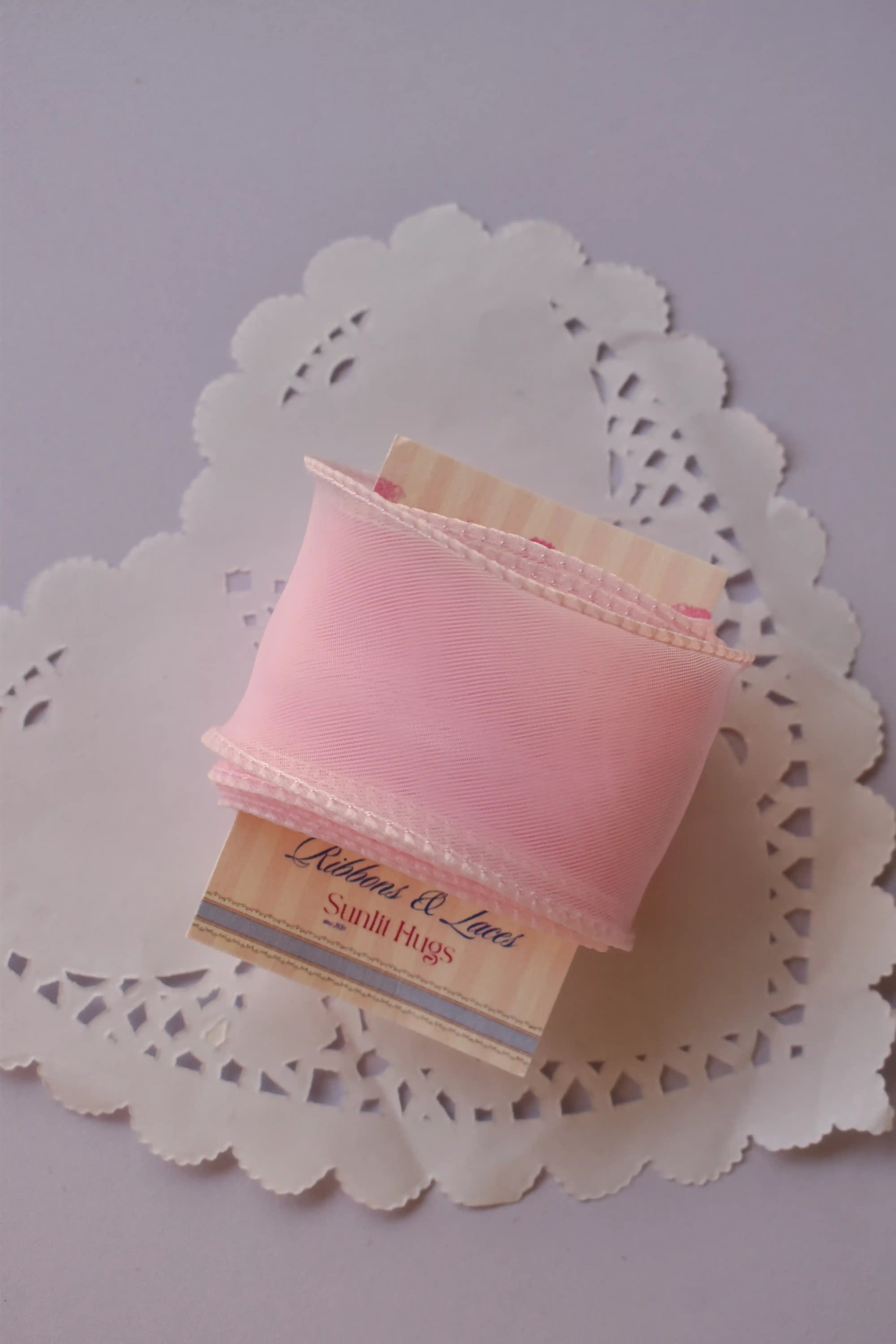 Extra-wide sheer pink organza ribbon (40mm, 2 Metres) gracefully draped around a "Sunlit Hugs" card on a lace doily.