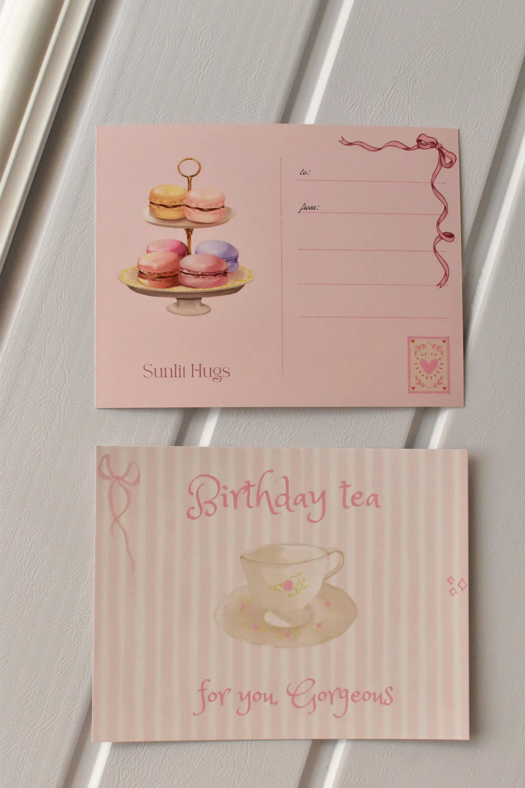 This view displays both the front and back design together, illustrating the full elegance of the Birthday Tea Postcard design set against a neutral background.