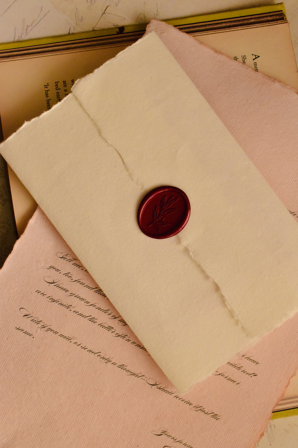 A clean, top-down view of the handmade ivory envelope, showcasing the striking scarlet red wax seal that makes this letter a profound and tangible piece of romantic art.