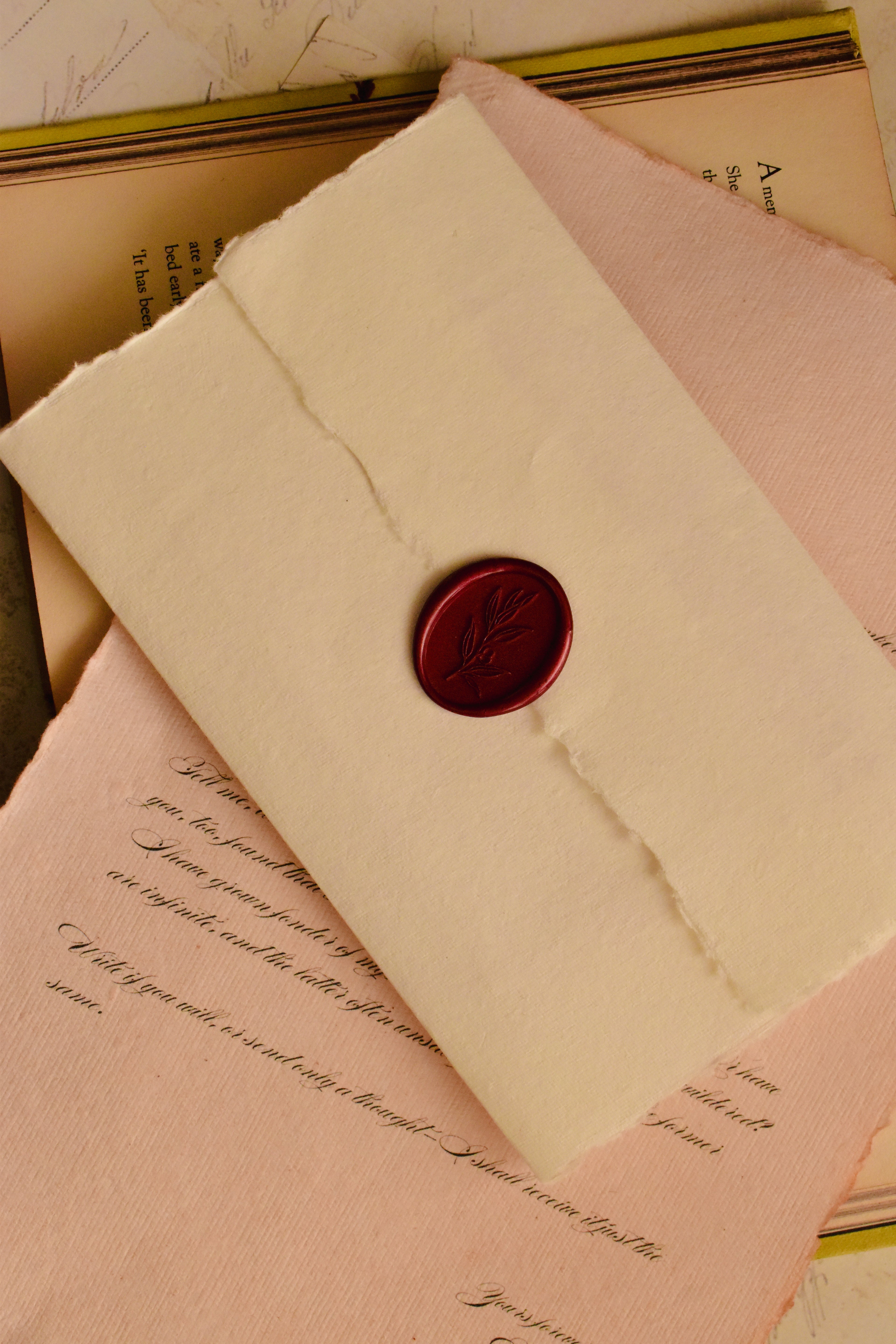 A clean, top-down view of the handmade ivory envelope, showcasing the striking scarlet red wax seal that makes this letter a profound and tangible piece of romantic art.