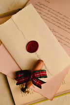 A clean, top-down view of the handmade ivory envelope, showcasing the striking scarlet red wax seal that makes this letter a profound and tangible piece of romantic art.