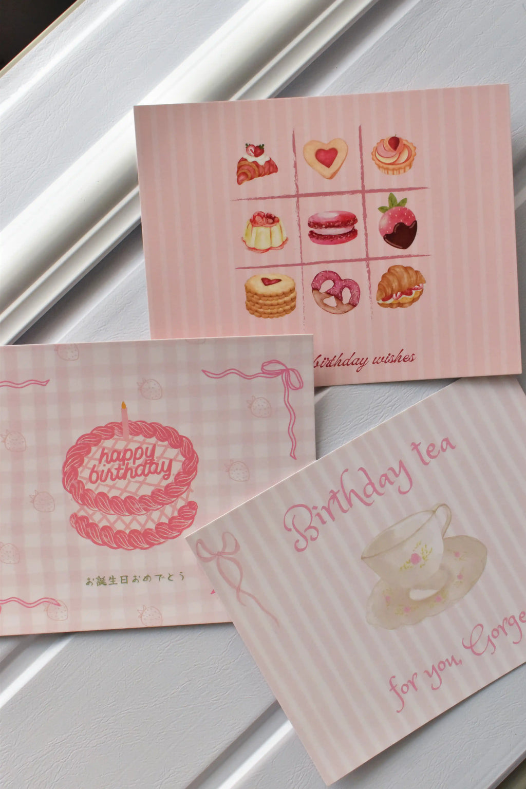 This image displays the variety of the Dessert Birthday Postcard Set, showing the cake, tea, and baked goods designs together in a cheerful arrangement.