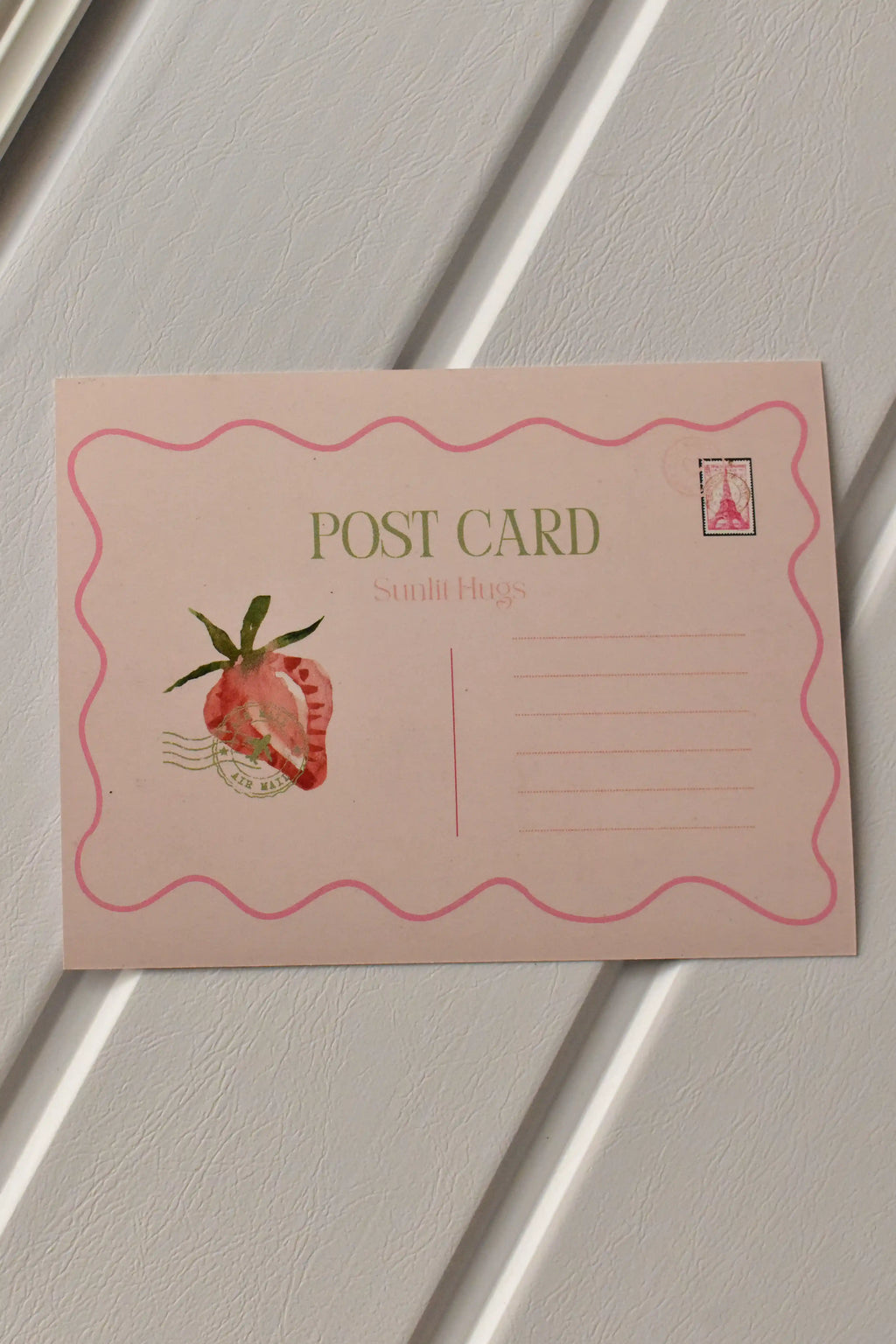 This clear view shows the back of the Strawberry Birthday Postcard, highlighting the pink strawberry illustration and the structured lines for the address and message.