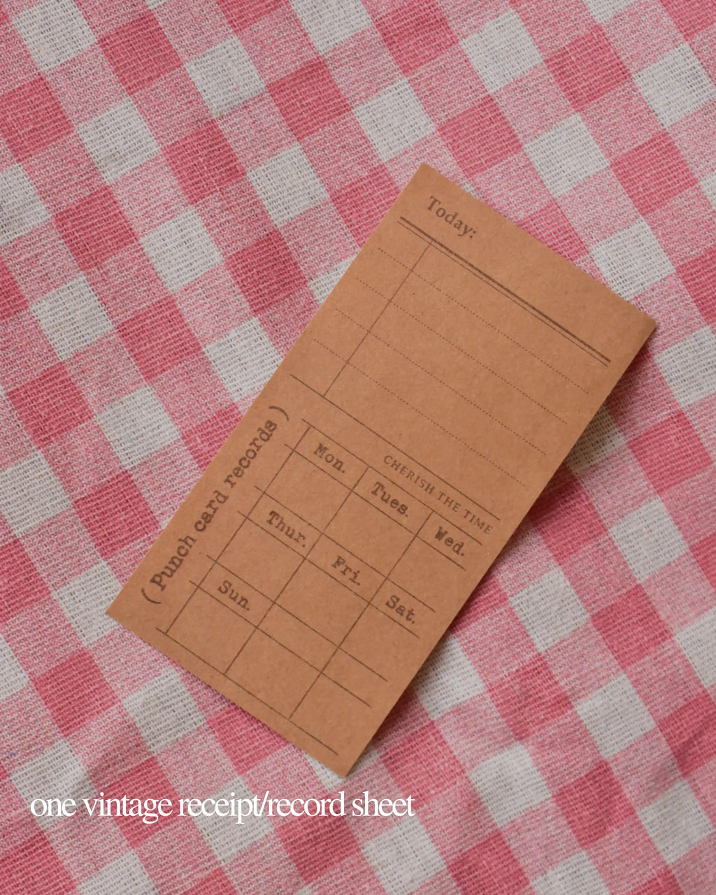 One vintage brown punch card record sheet with lines for recording daily activities and times.